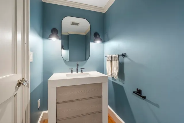 a bathroom with a sink mirror and vanity