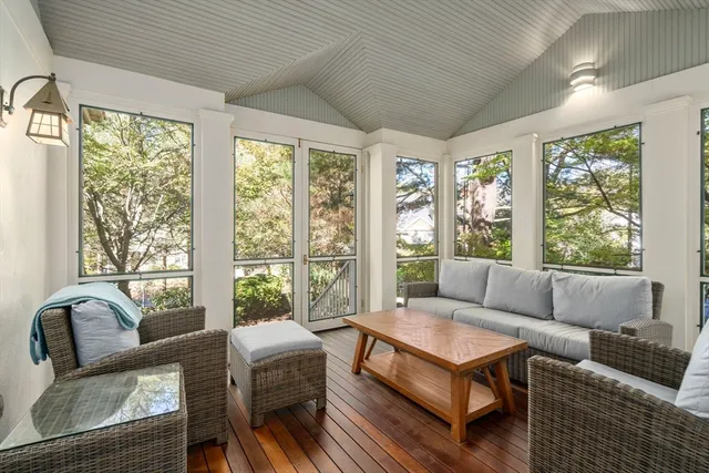 a living room with furniture and a floor to ceiling window