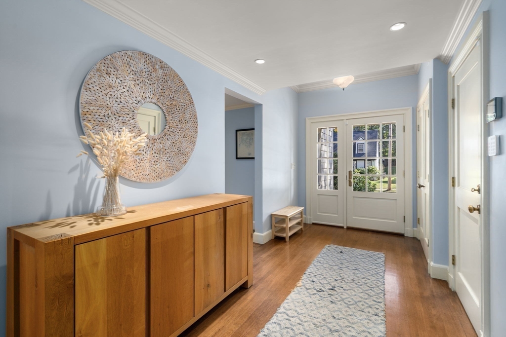 131 Oliver Road Newton, MA 02468 - Photo 14 of 33 a view of a hallway with a window and a mirror