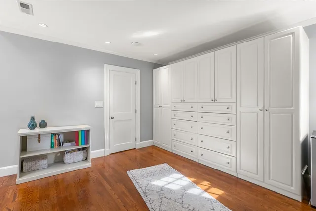 a view of a bedroom with cabinet and mirror