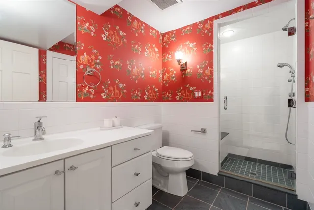 a bathroom with a sink toilet and shower