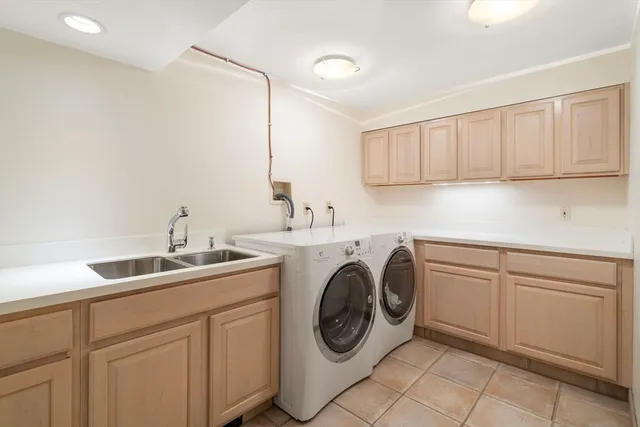 a utility room with sink dryer and washer