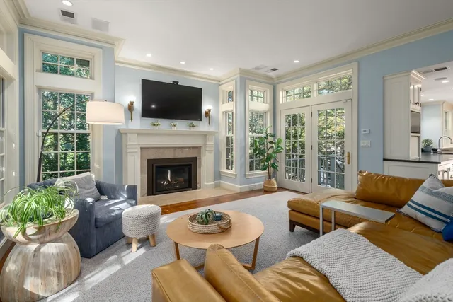 a living room with furniture fireplace and window