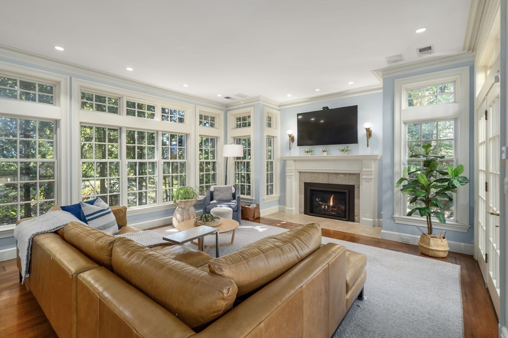 131 Oliver Road Newton, MA 02468 - Photo 5 of 33 a living room with furniture a flat screen tv and a fireplace