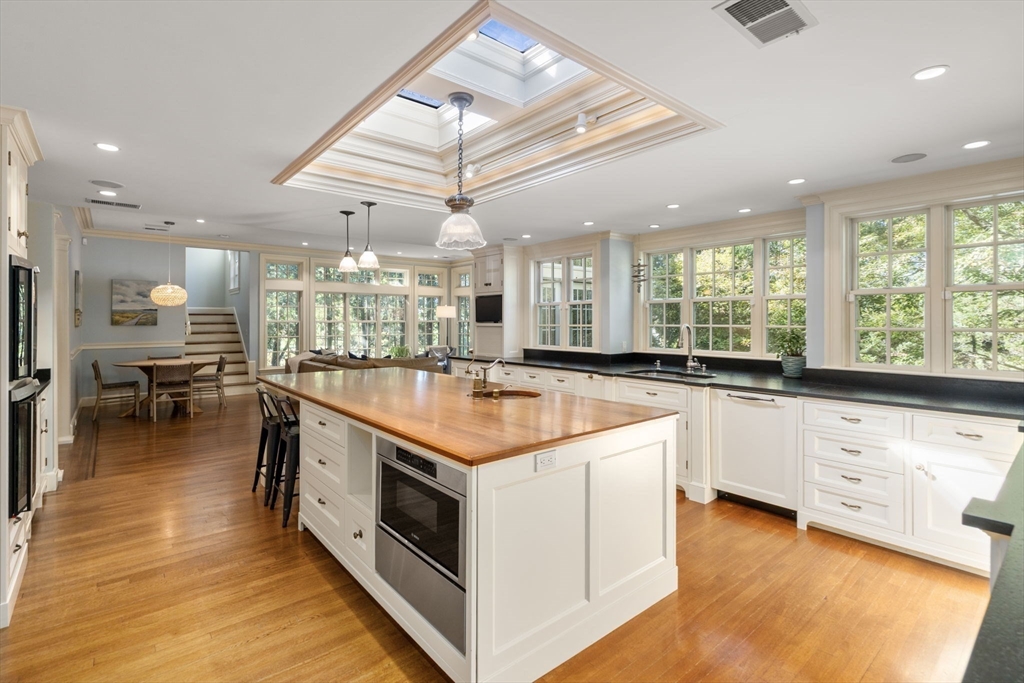 131 Oliver Road Newton, MA 02468 - Photo 8 of 33 a large kitchen with stainless steel appliances granite countertop a large counter top a stove and a refrigerator