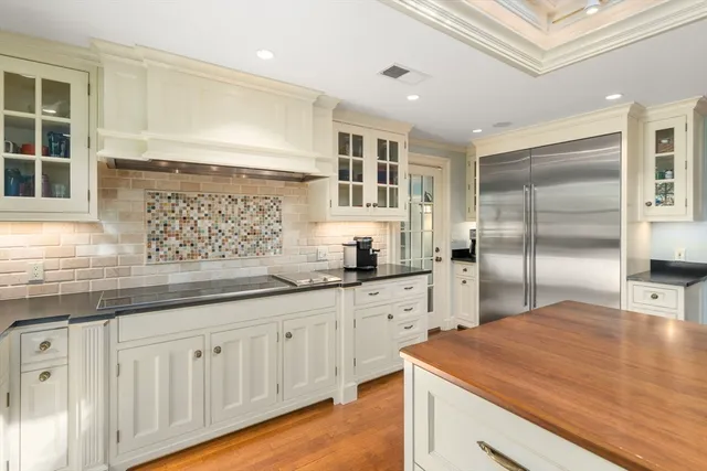 a kitchen with stainless steel appliances granite countertop a sink and dishwasher with white cabinets
