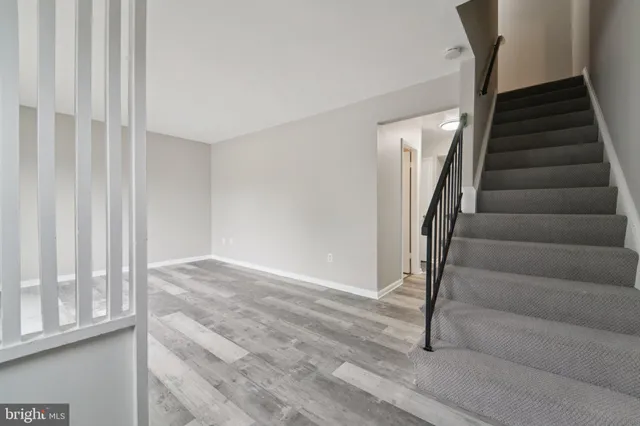 a kitchen with granite countertop white cabinets and stainless steel appliances