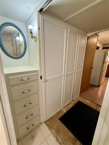 a kitchen with refrigerator and mirror