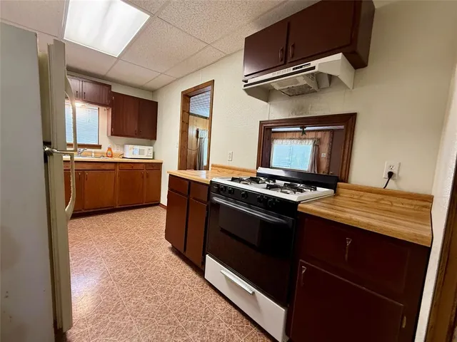a room with wooden floor and cabinets