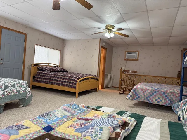 a view of hall way with furniture a flat screen tv and a fireplace