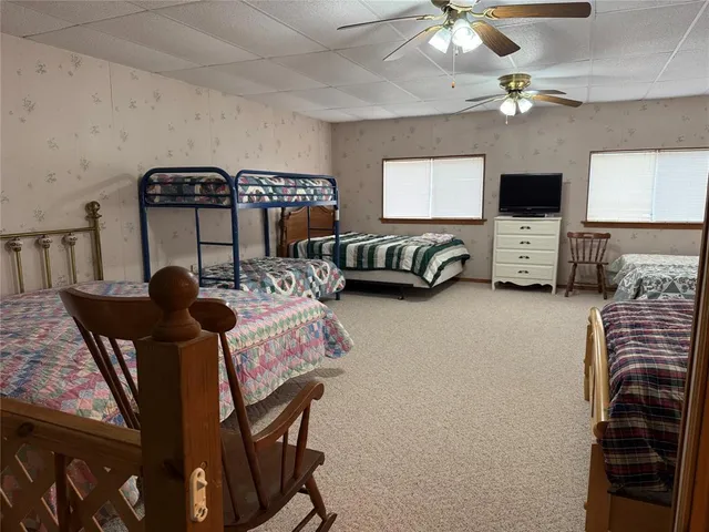a very nice looking bedroom with a large window and a rug