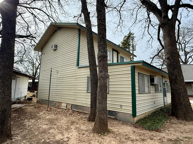 a view of a house with a yard and wooden fence