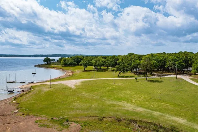 an aerial view of a house with a garden and lake view