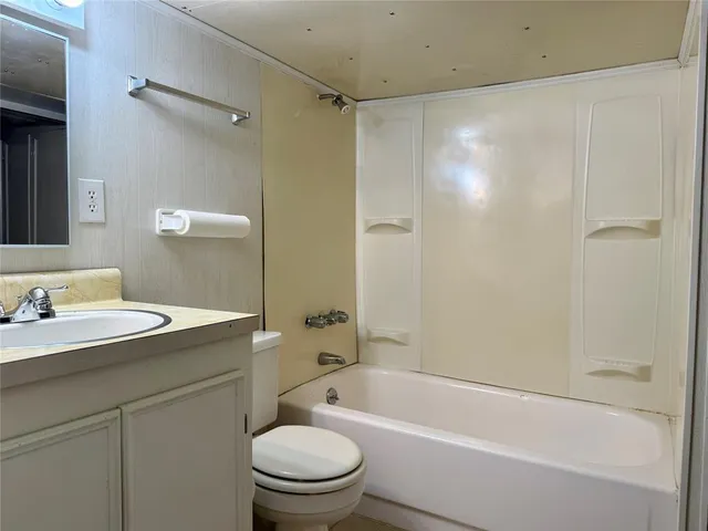 a bathroom with a sink toilet and a mirror