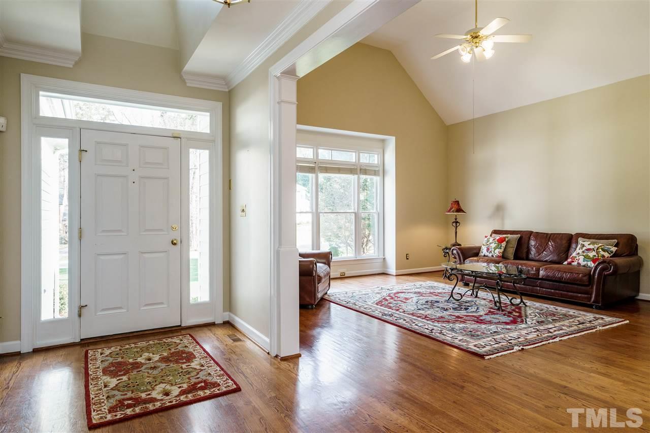 412 Chatterson Drive Raleigh, NC 27615 - Photo 4 of 30 Transitional plan; ceiling heights add to the sense of volume in this light-filled Living Room with Built-in Book Cases and a cozy Fireplace. Hardwood floors are a perfect color to coordinate with a variety of decor styles.