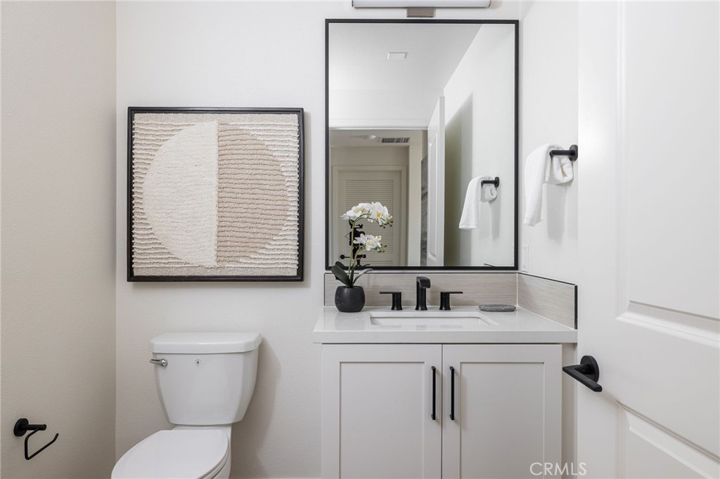 414 Main Street, Unit 330 Huntington Beach, CA 92648 - Photo 15 of 42 a bathroom with a toilet sink and mirror
