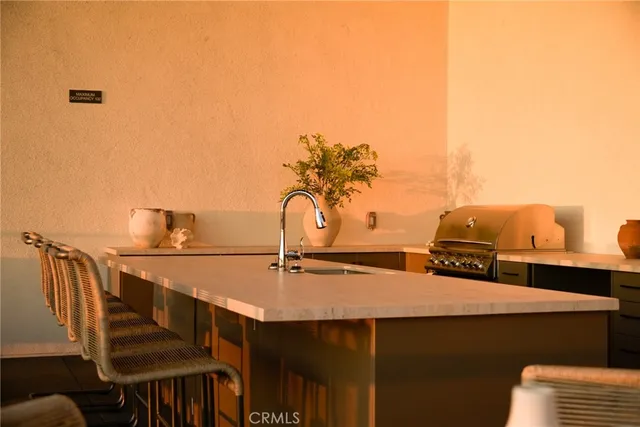 a living room with a couch and a lamp on dresser
