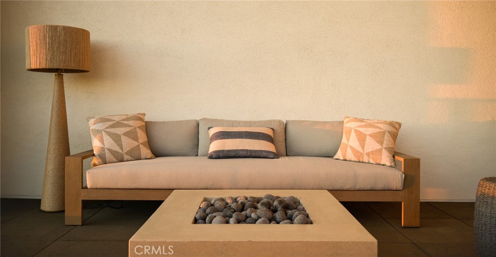 414 Main Street, Unit 330 Huntington Beach, CA 92648 - Photo 26 of 42 a living room with a couch and a lamp on dresser