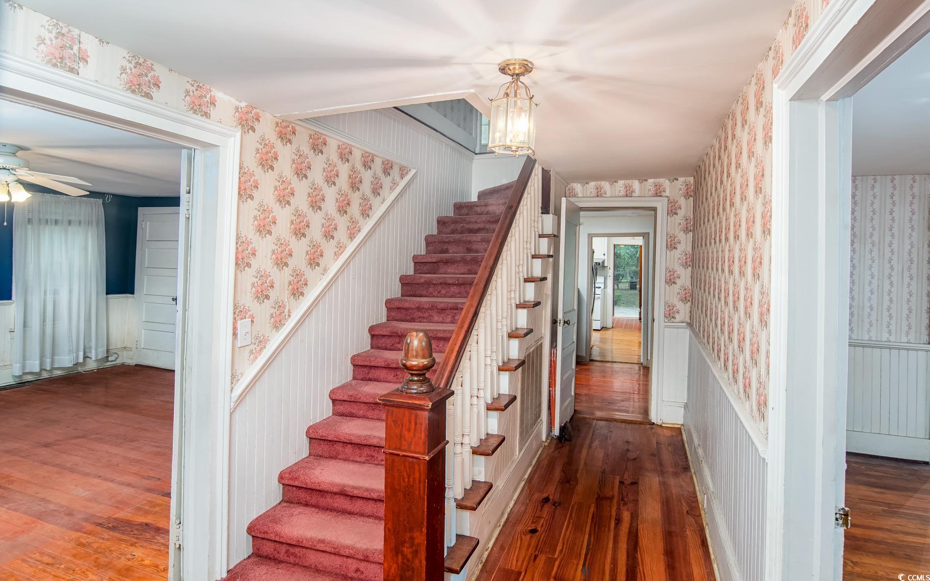1010 Highmarket Street Georgetown, SC 29440 - Photo 5 of 32 Stairs featuring wood-type flooring, wainscoting, and wallpapered walls