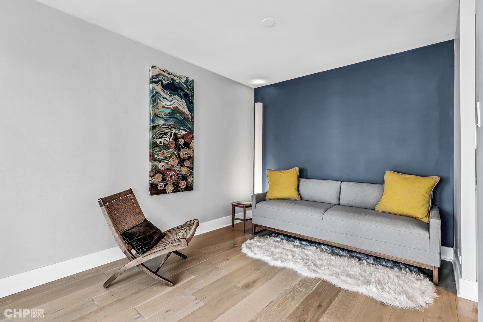 111 East Chestnut Street, Unit 49H Chicago, IL 60611 - Photo 11 of 27 a living room with a couch and painting on the wall