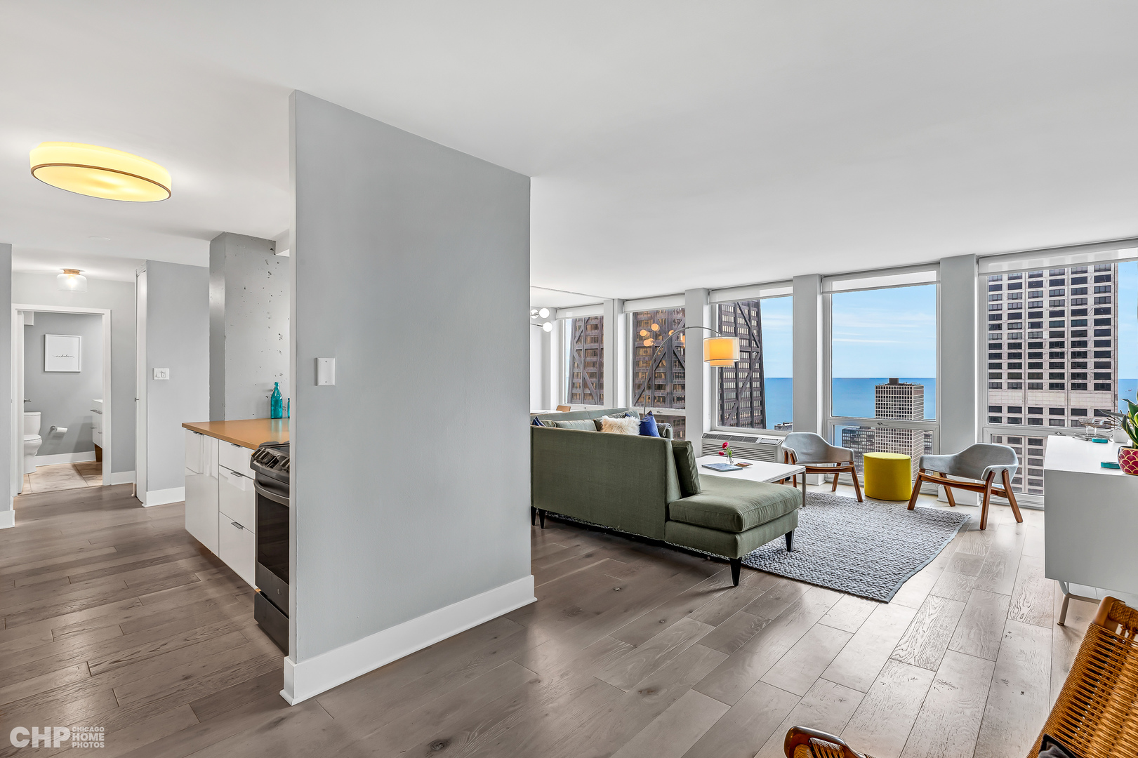 111 East Chestnut Street, Unit 49H Chicago, IL 60611 - Photo 12 of 27 a living room with furniture and a large window