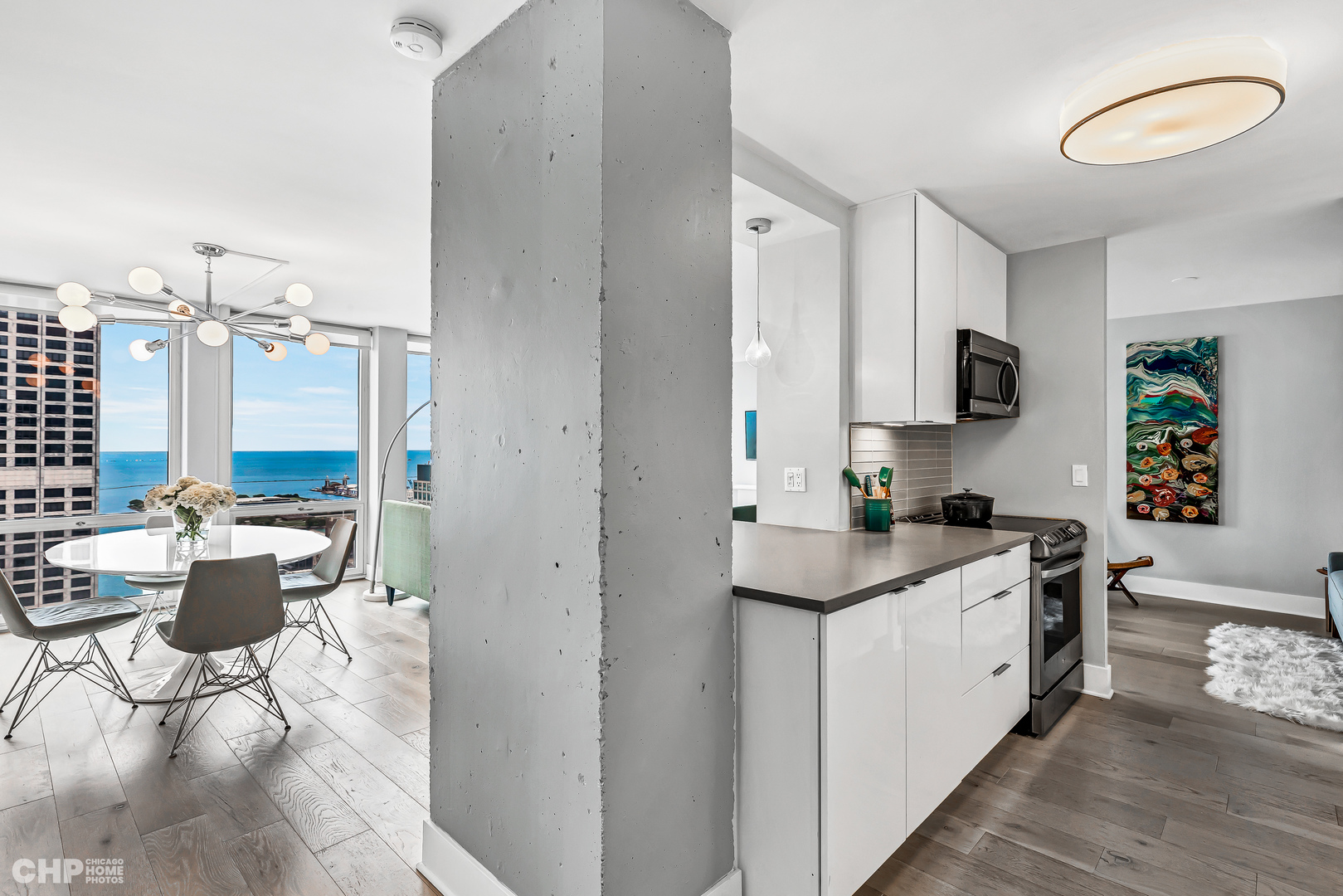 111 East Chestnut Street, Unit 49H Chicago, IL 60611 - Photo 14 of 27 a kitchen with a sink stove and cabinets