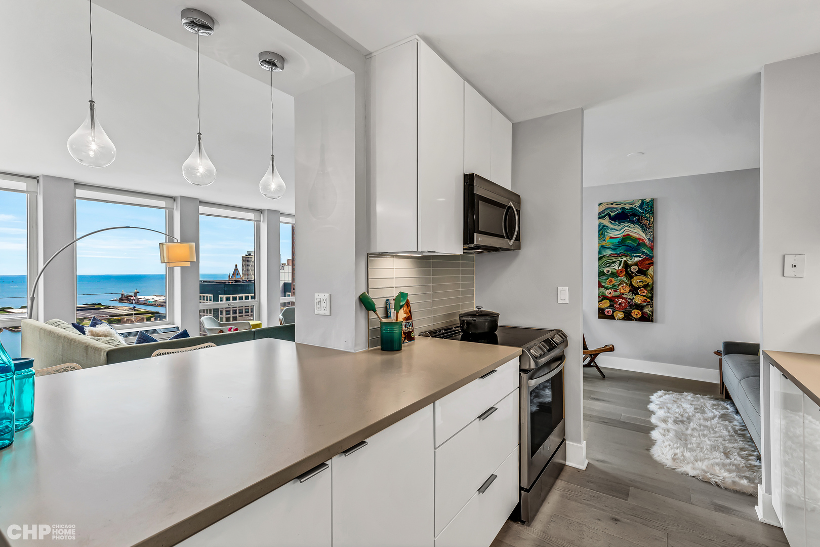 111 East Chestnut Street, Unit 49H Chicago, IL 60611 - Photo 15 of 27 a kitchen with stainless steel appliances granite countertop a sink a stove and a refrigerator