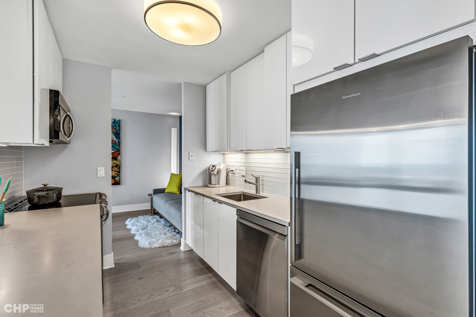 111 East Chestnut Street, Unit 49H Chicago, IL 60611 - Photo 16 of 27 a kitchen with stainless steel appliances granite countertop a sink and a stove