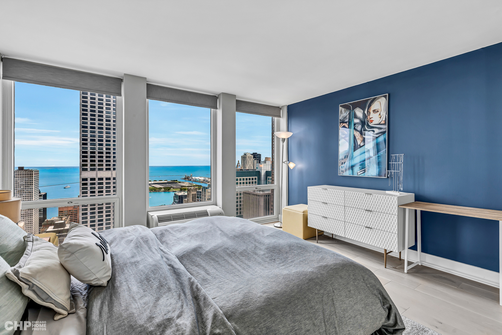111 East Chestnut Street, Unit 49H Chicago, IL 60611 - Photo 19 of 27 a bedroom with a bed and wooden floor