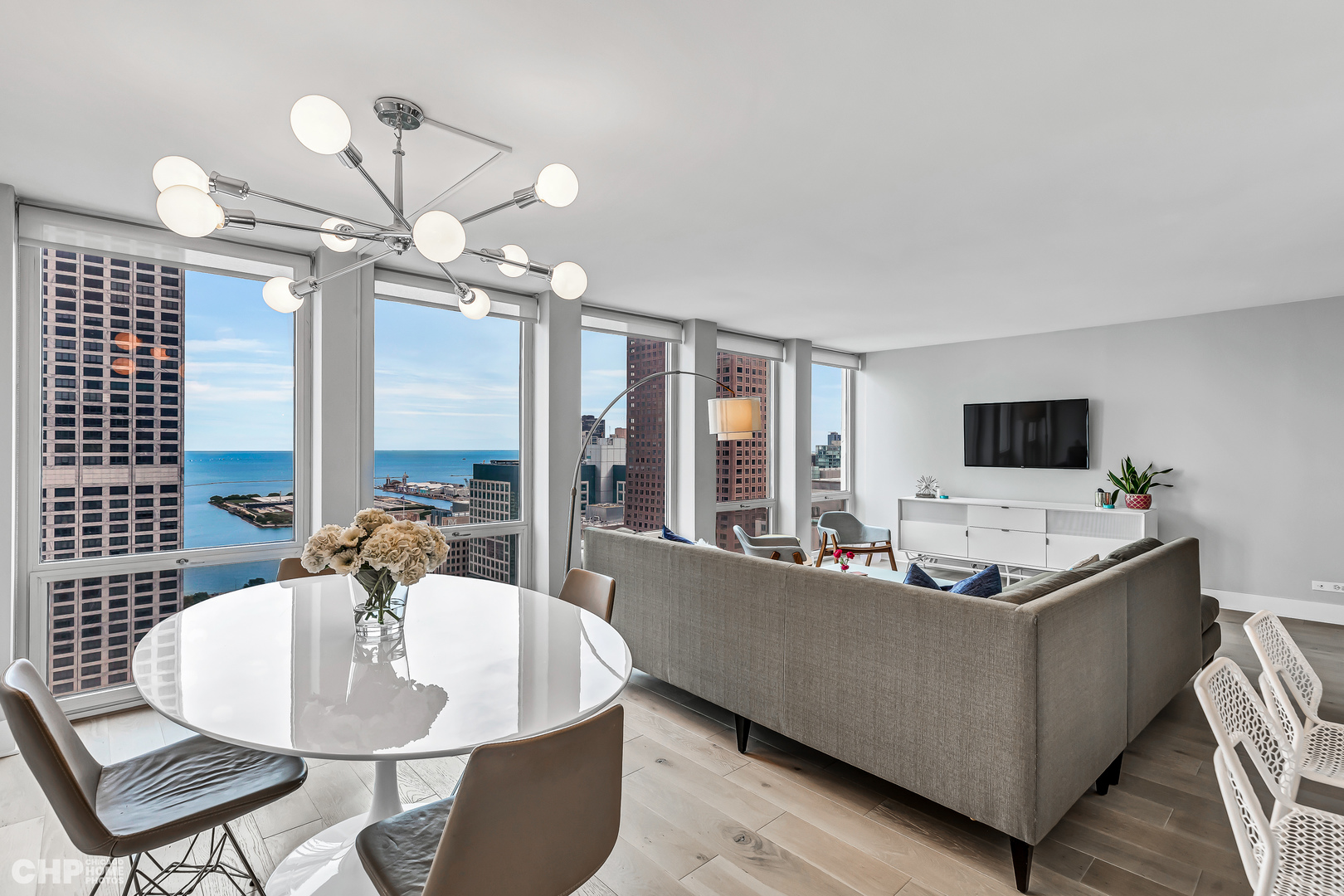 111 East Chestnut Street, Unit 49H Chicago, IL 60611 - Photo 4 of 27 a living room with furniture and a flat screen tv