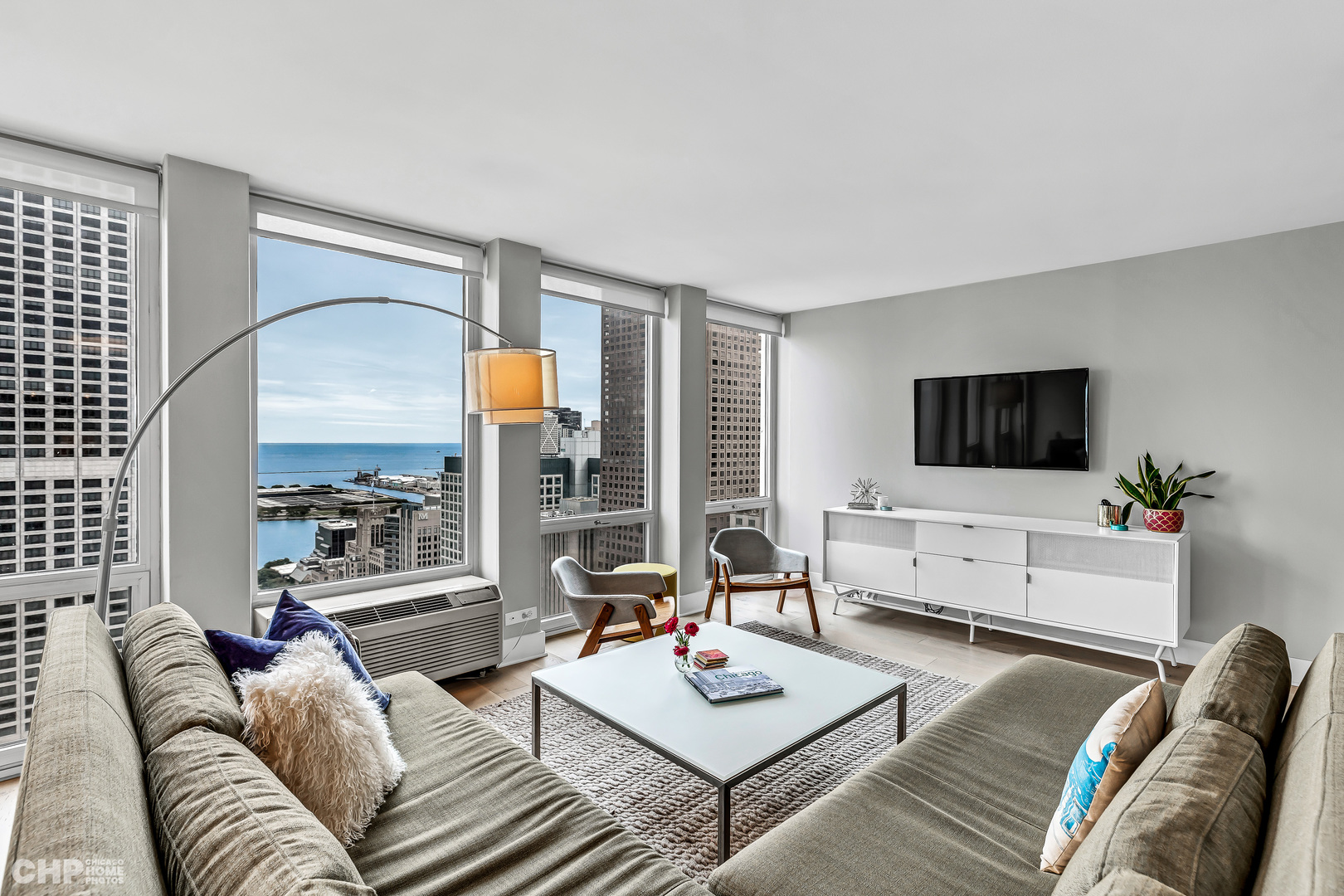 111 East Chestnut Street, Unit 49H Chicago, IL 60611 - Photo 5 of 27 a living room with furniture and a flat screen tv