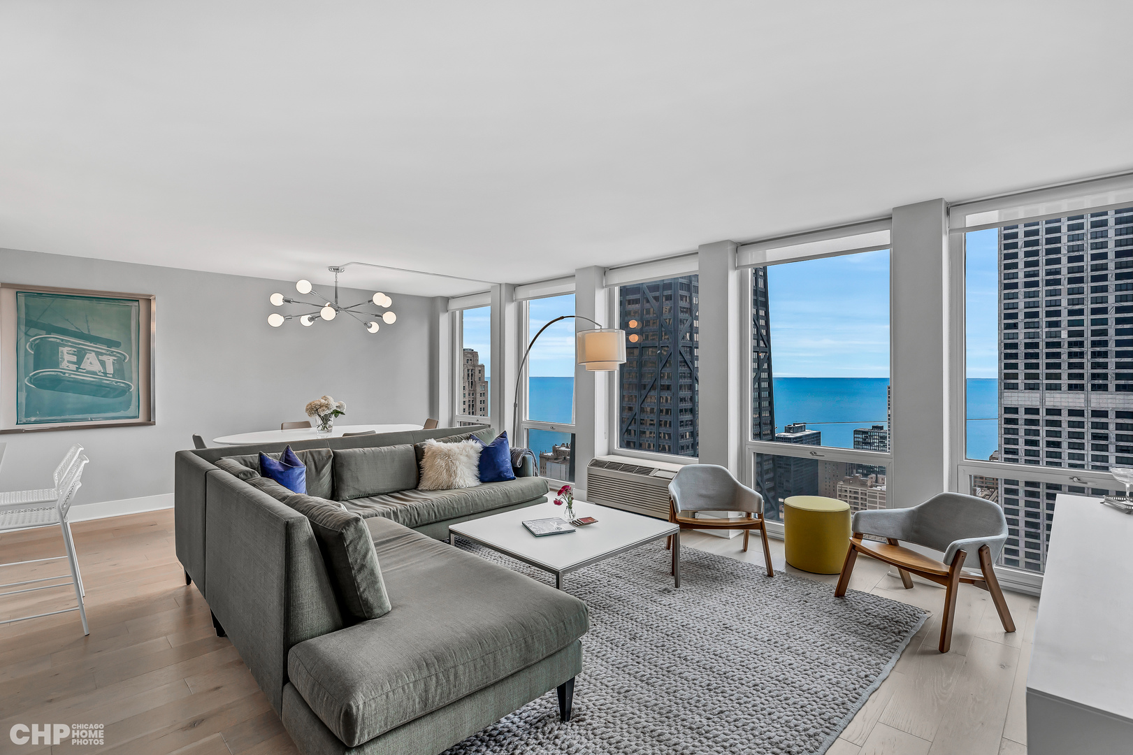 111 East Chestnut Street, Unit 49H Chicago, IL 60611 - Photo 7 of 27 a living room with furniture and a table