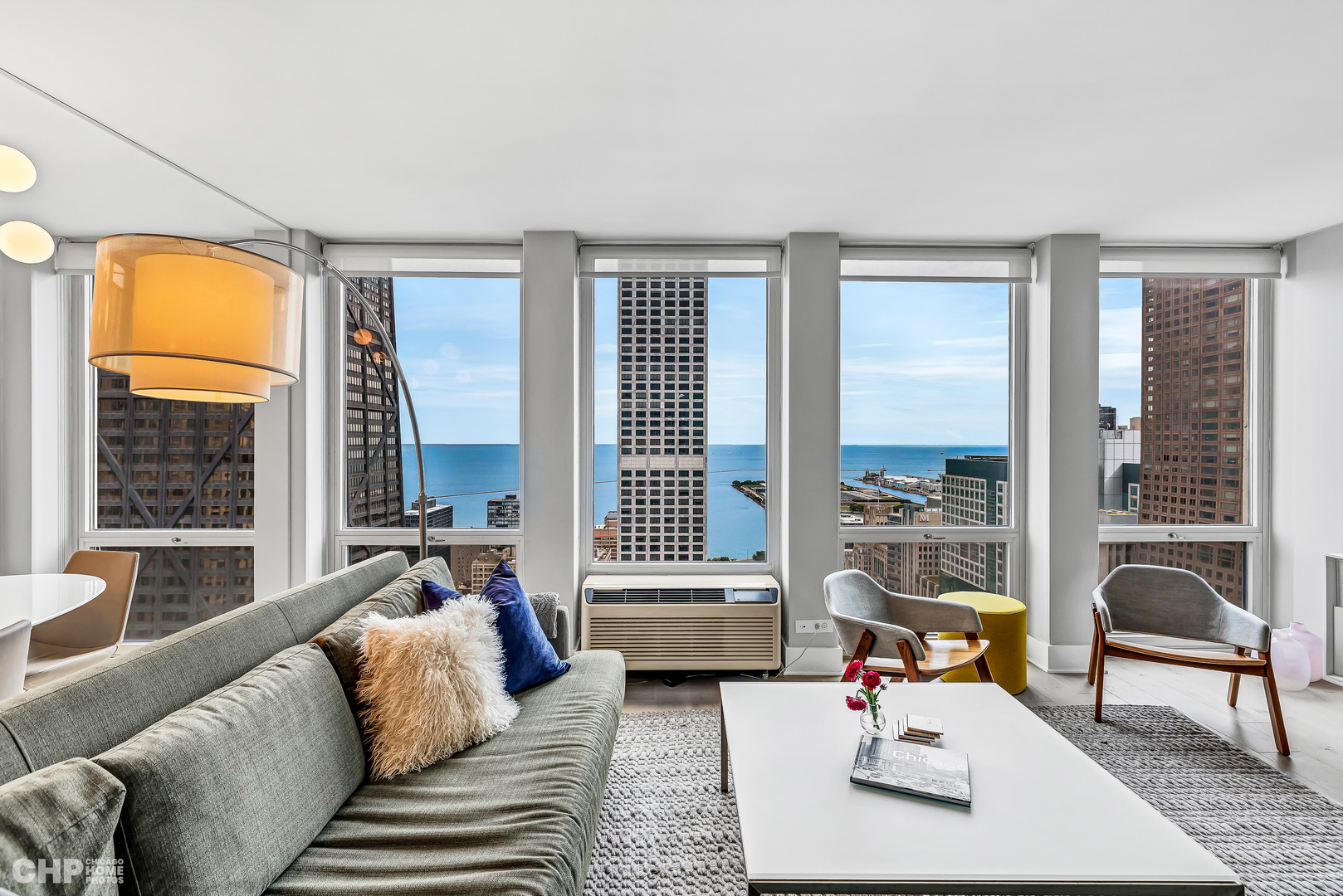 111 East Chestnut Street, Unit 49H Chicago, IL 60611 - Photo 8 of 27 a living room with furniture and a large window