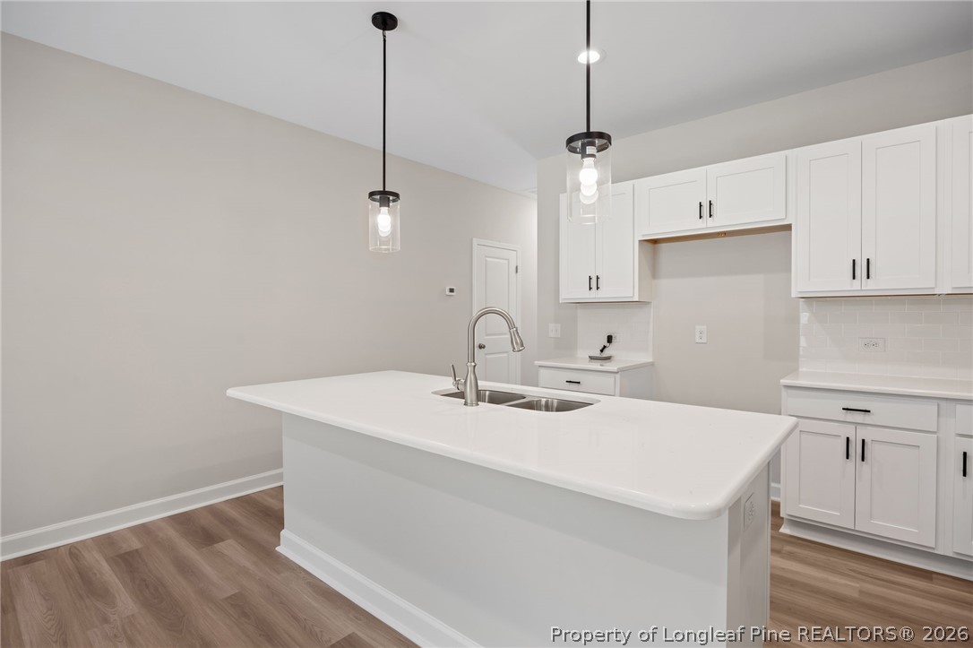 232 Elijah Way, Unit 8 Vass, NC 28394 - Photo 11 of 41 a kitchen with a sink cabinets and wooden floor