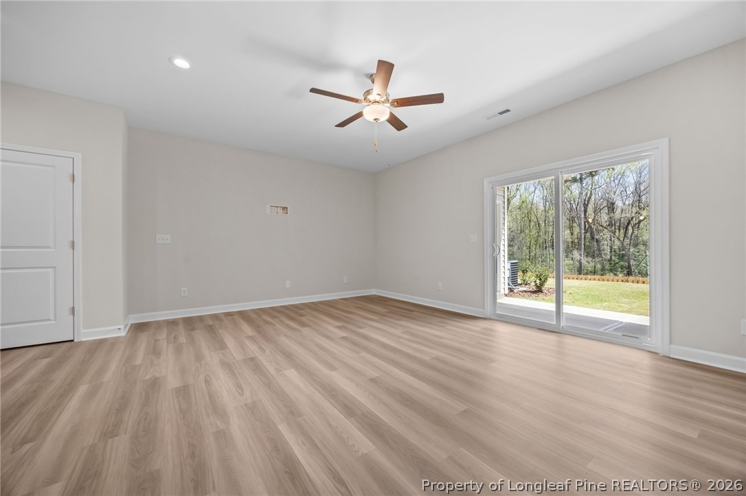 232 Elijah Way, Unit 8 Vass, NC 28394 - Photo 18 of 41 an empty room with wooden floor and windows