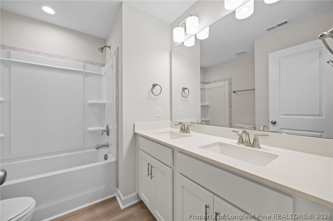 232 Elijah Way, Unit 8 Vass, NC 28394 - Photo 23 of 41 a bathroom with a tub a sink and mirror