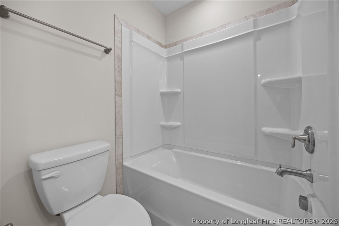 232 Elijah Way, Unit 8 Vass, NC 28394 - Photo 24 of 41 a white bath tub sitting next to a toilet
