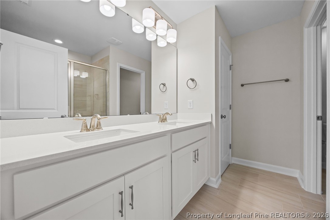 232 Elijah Way, Unit 8 Vass, NC 28394 - Photo 28 of 41 a bathroom with a double vanity sink and a mirror