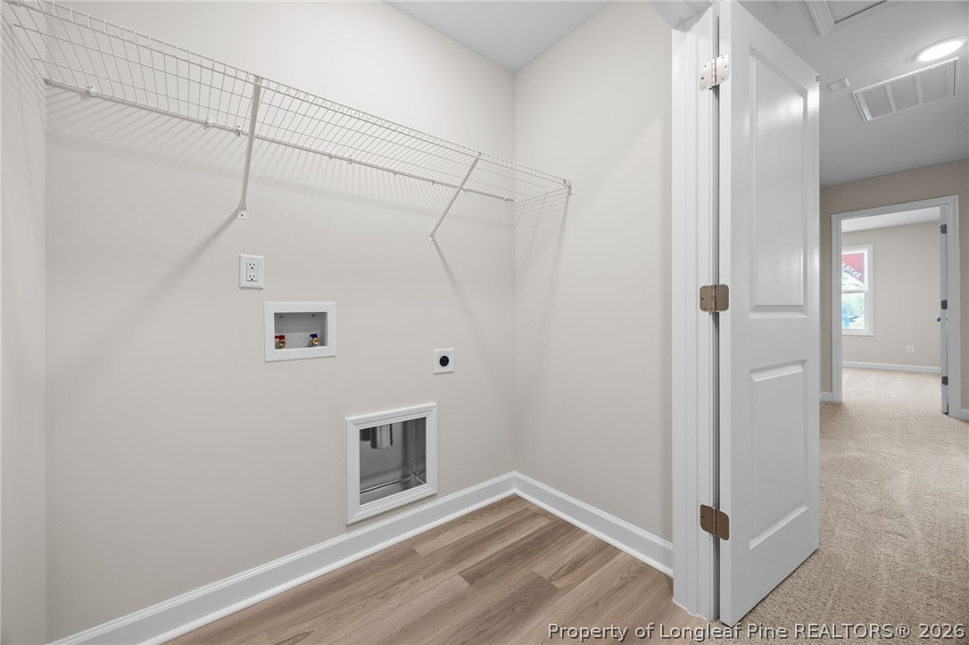 232 Elijah Way, Unit 8 Vass, NC 28394 - Photo 30 of 41 a view of a livingroom with wooden floor and a ceiling fan