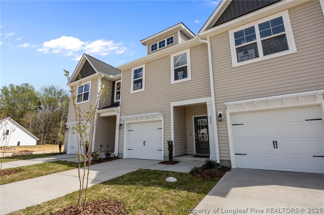 232 Elijah Way, Unit 8 Vass, NC 28394 - Photo 3 of 41 a front view of a house with a yard