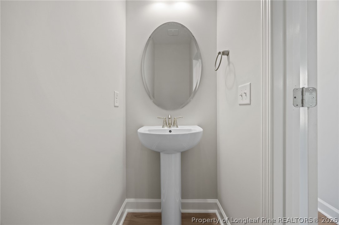 232 Elijah Way, Unit 8 Vass, NC 28394 - Photo 6 of 41 a bathroom with a sink a mirror and a shower