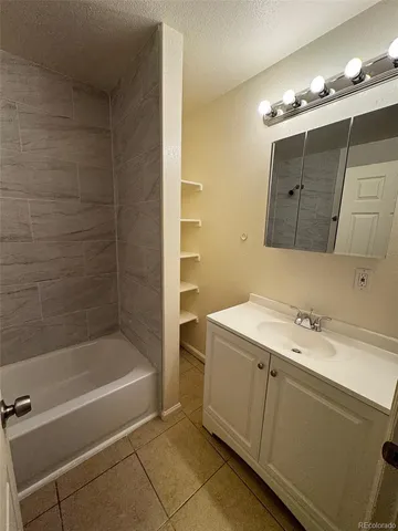 a bathroom with a sink a toilet a mirror and shower