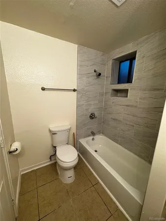 a bathroom with a toilet and a bath tub