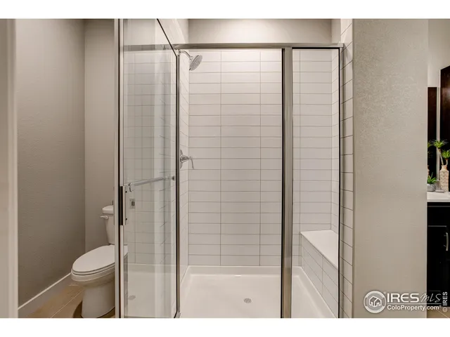 a bathroom with a shower and a toilet