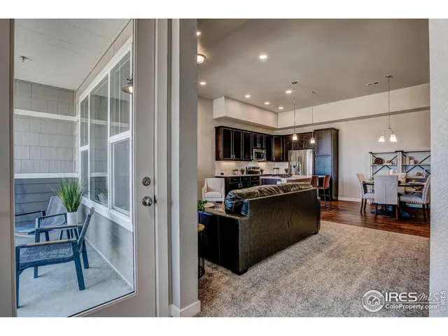 a kitchen with stainless steel appliances kitchen island granite countertop a refrigerator and a sink