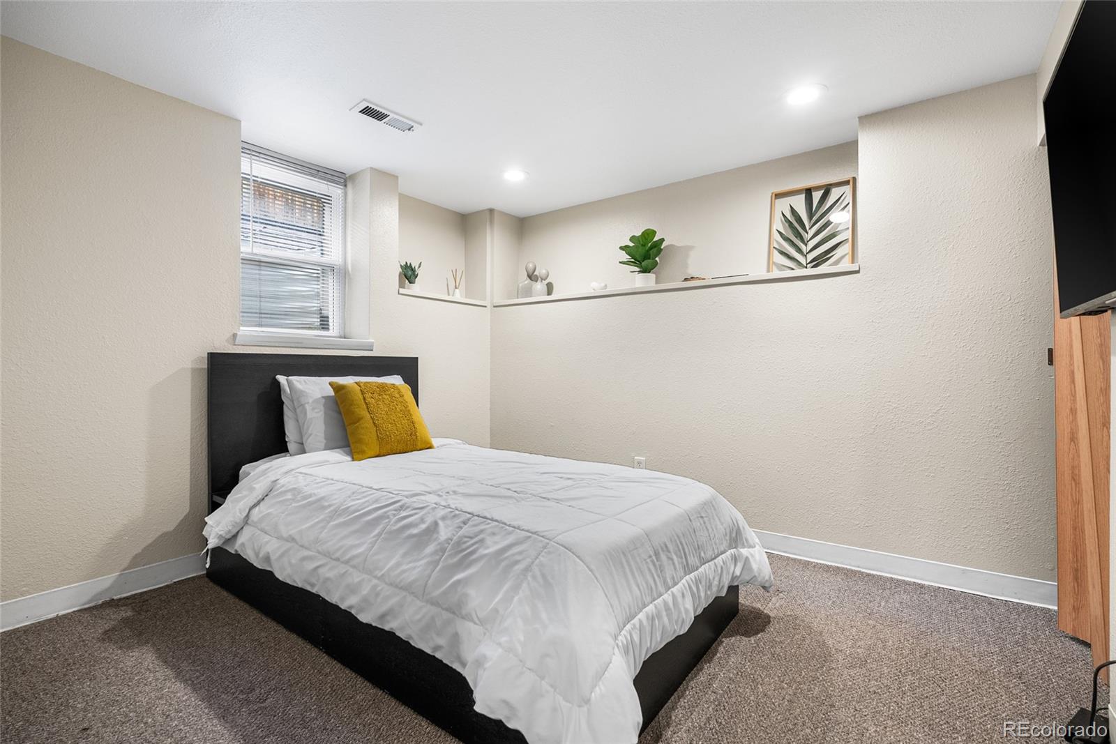 4546 Meade Street Denver, CO 80211 - Photo 16 of 35 a bedroom with a bed and a wall painting