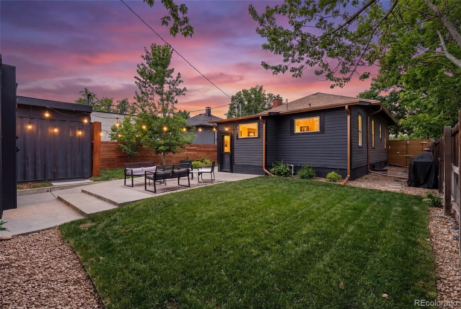4546 Meade Street Denver, CO 80211 - Photo 18 of 35 a front view of a house with a garden and patio