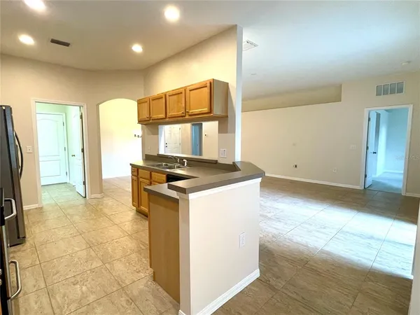 a kitchen with a stove a refrigerator and a sink