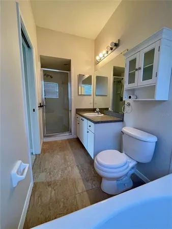 a bathroom with a toilet sink and mirror