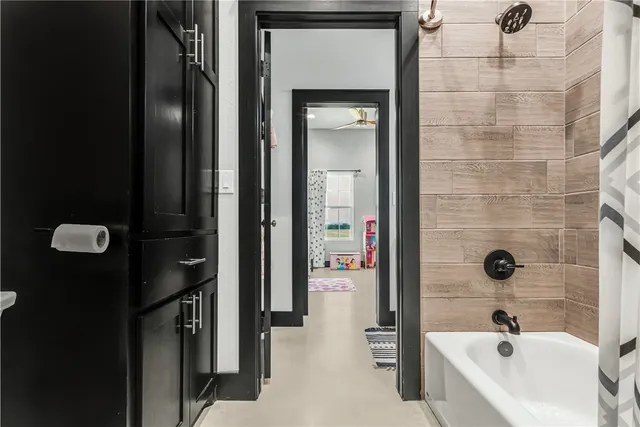 a bathroom with a tub and a shower